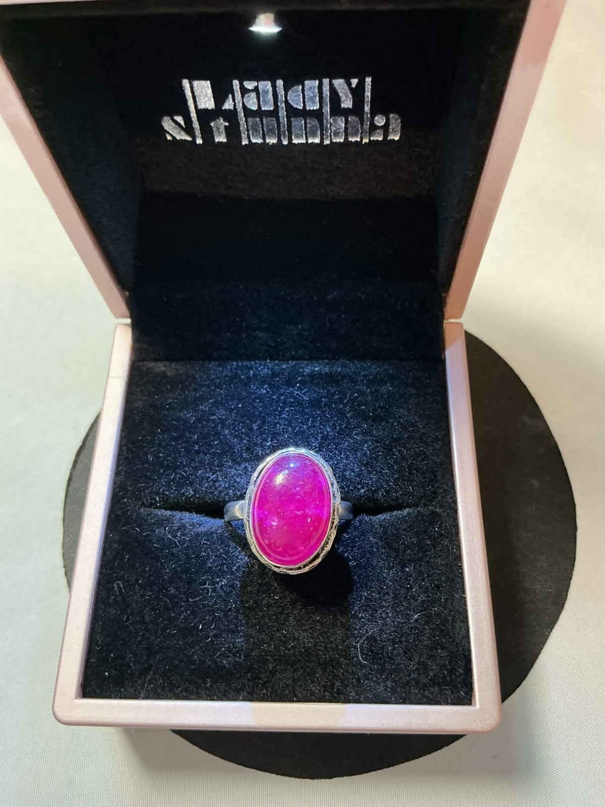 sterling silver ring featuring a pink corundum or chalcedony gemstone.