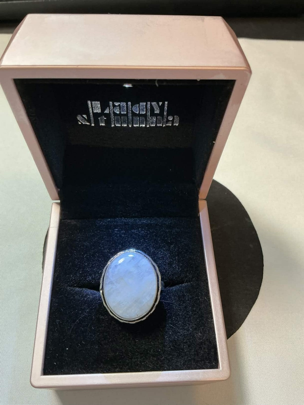 sterling silver ring featuring an oval-shaped Rainbow Moonstone gemstone.