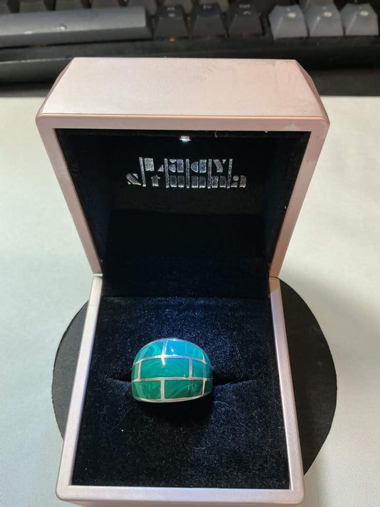 sterling silver ring featuring a green turquoise brick inlay pattern.