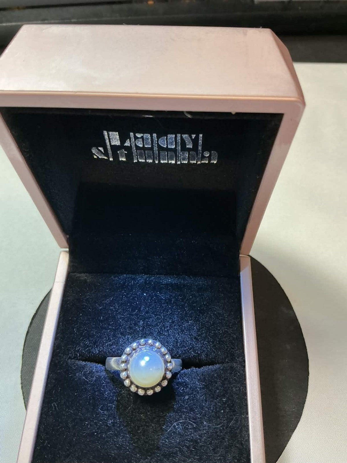 moonstone cabochon set in sterling silver, featuring a beaded halo design simil