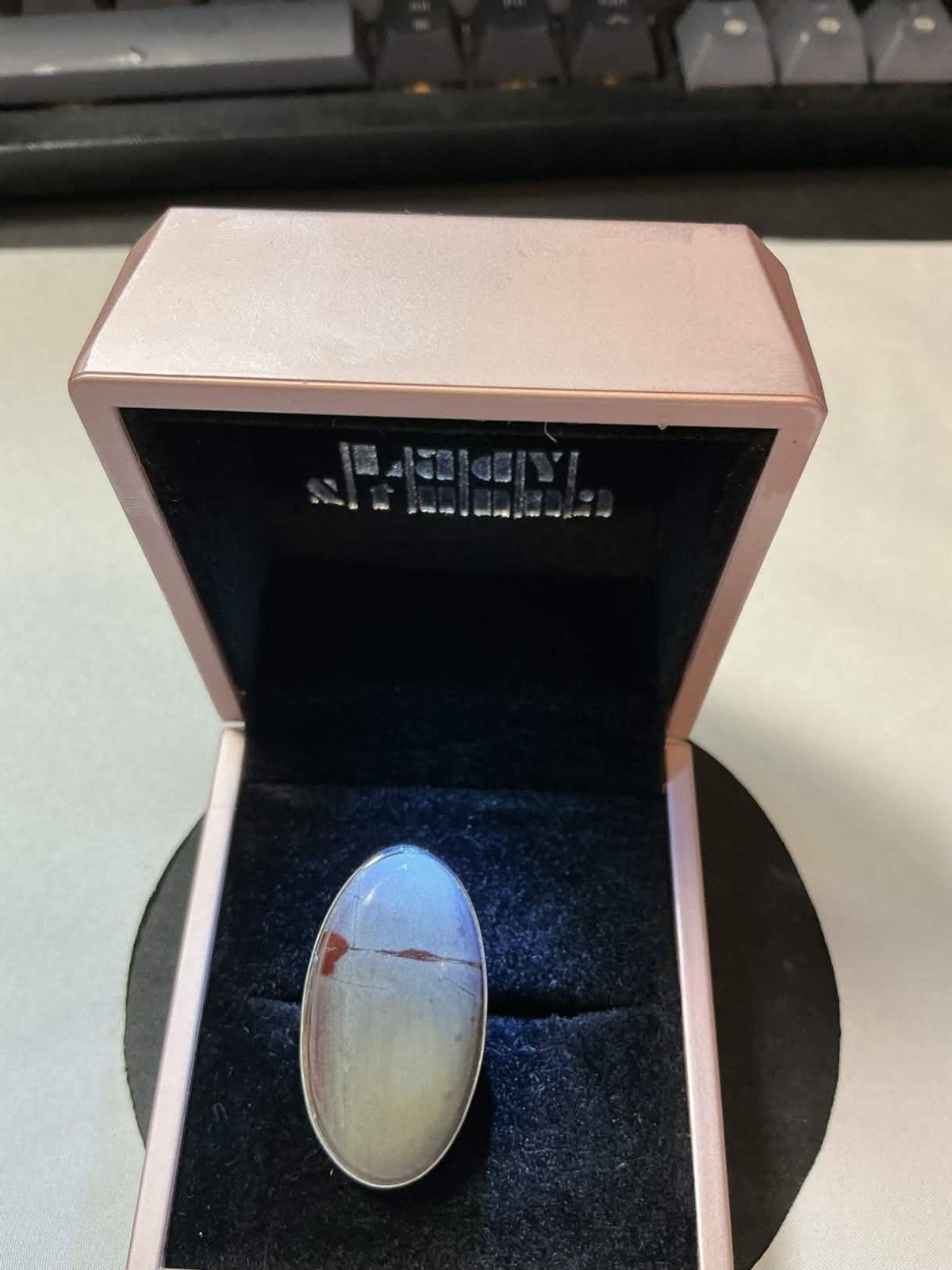 large, oval-shaped cabochon stone in a sterling silver setting