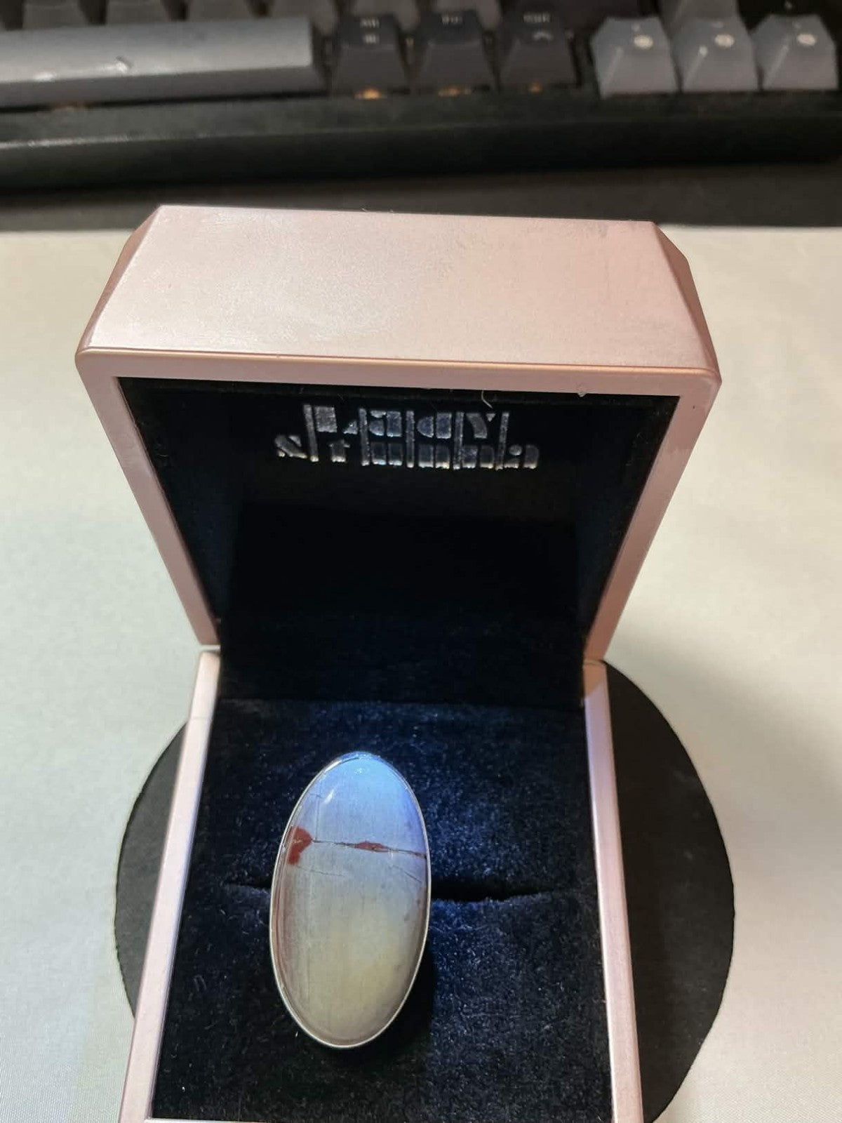 large, oval-shaped cabochon stone in a sterling silver setting