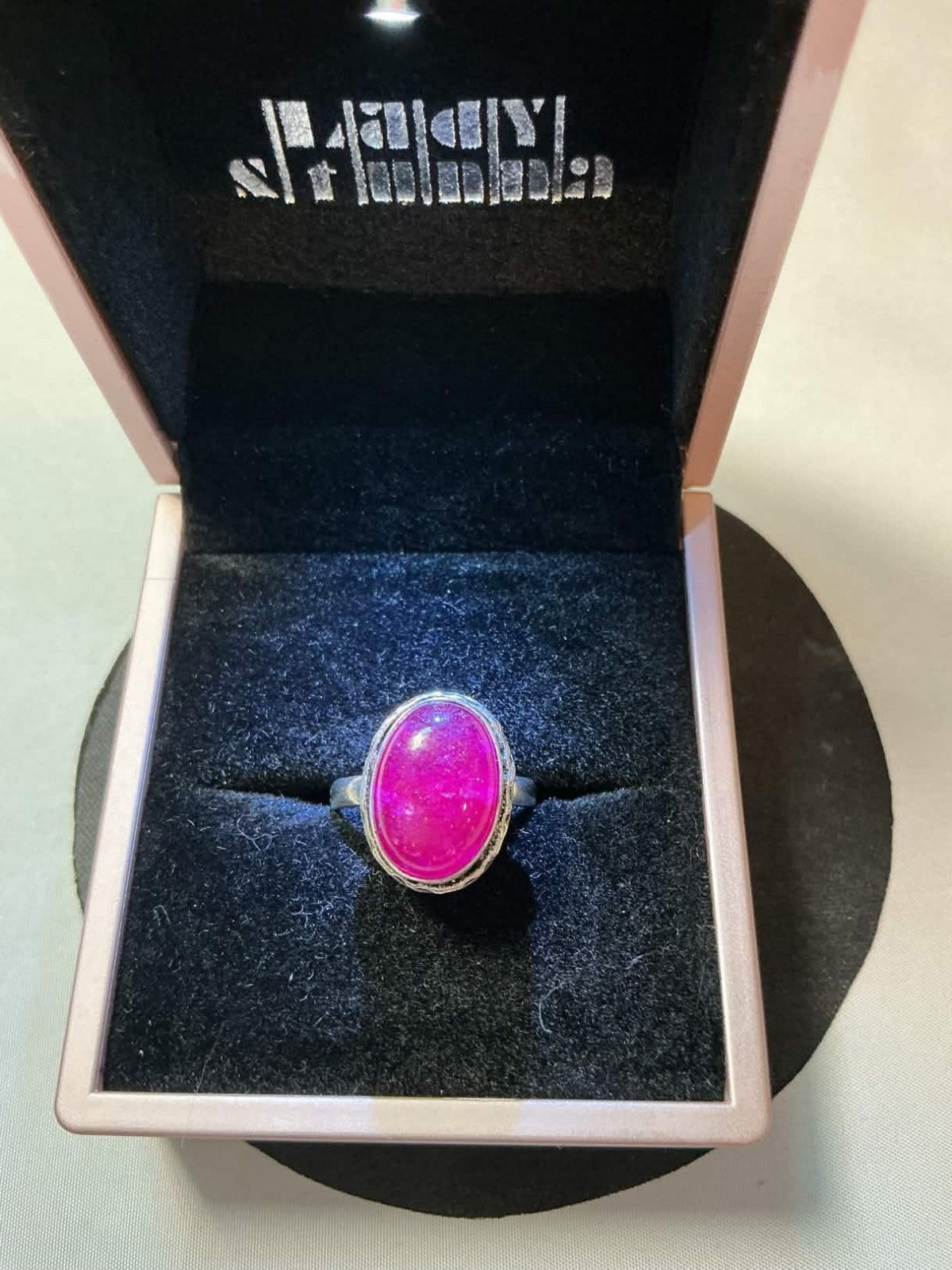 sterling silver ring featuring a pink corundum or chalcedony gemstone.