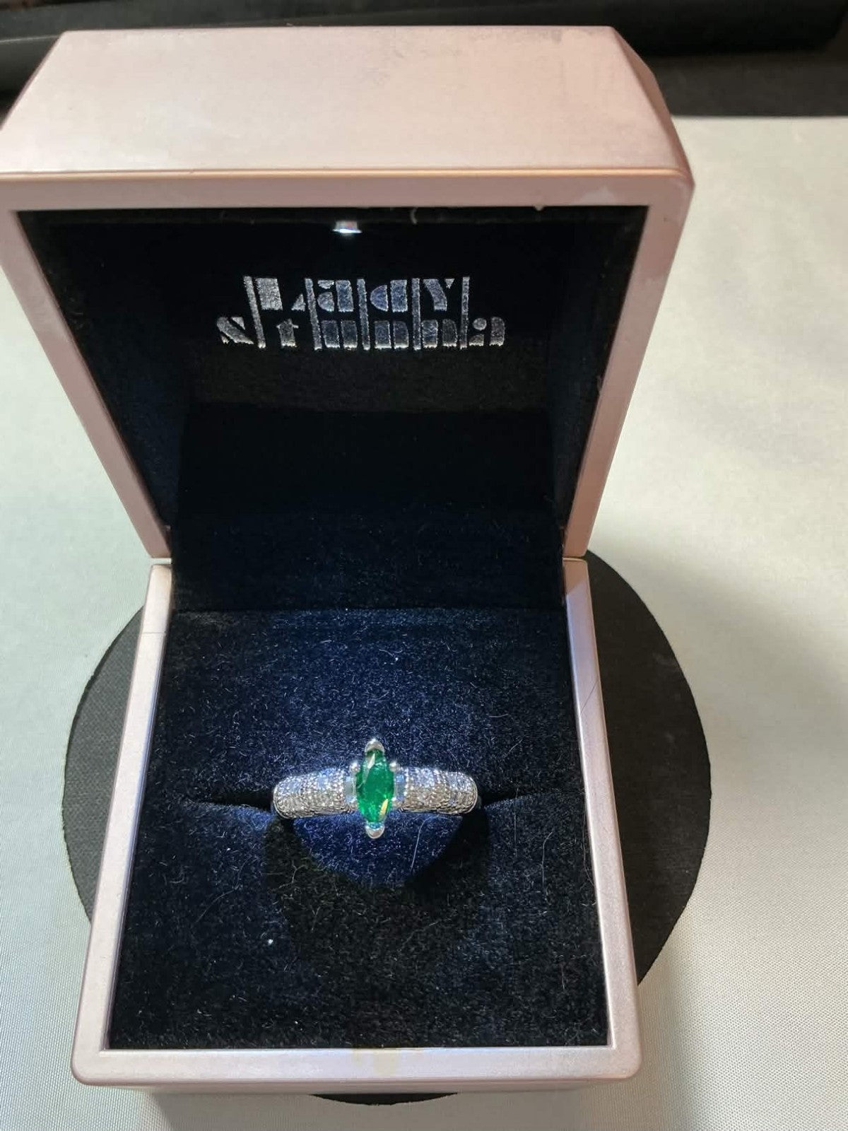 marquise-cut emerald surrounded by diamonds