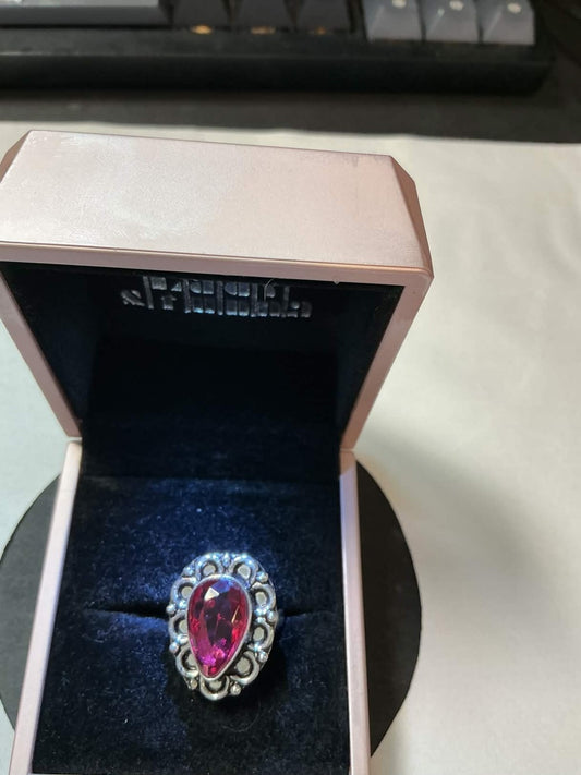 925 sterling silver ring featuring a large, pear-shaped pink gemstone, often des