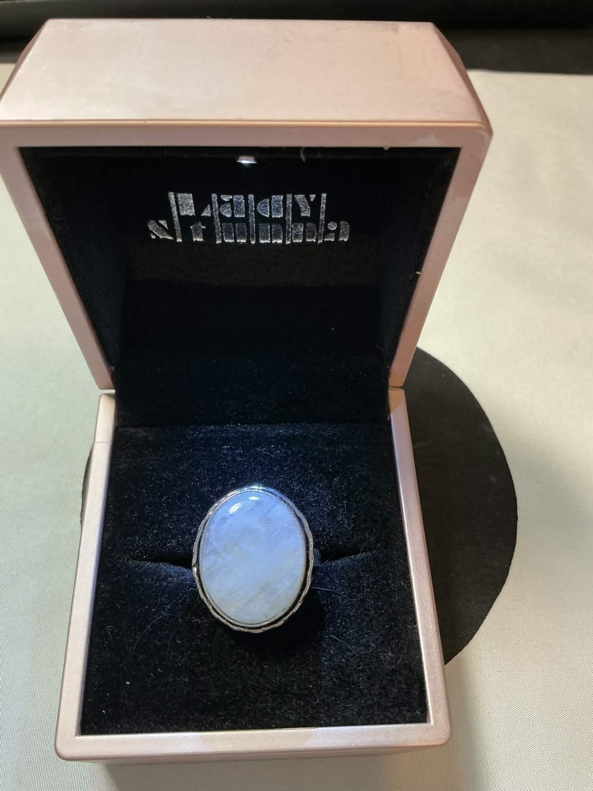 sterling silver ring featuring an oval-shaped Rainbow Moonstone gemstone.