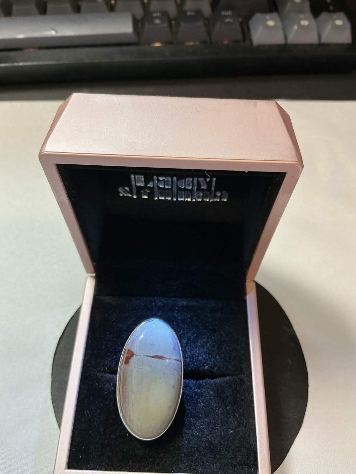 large, oval-shaped cabochon stone in a sterling silver setting