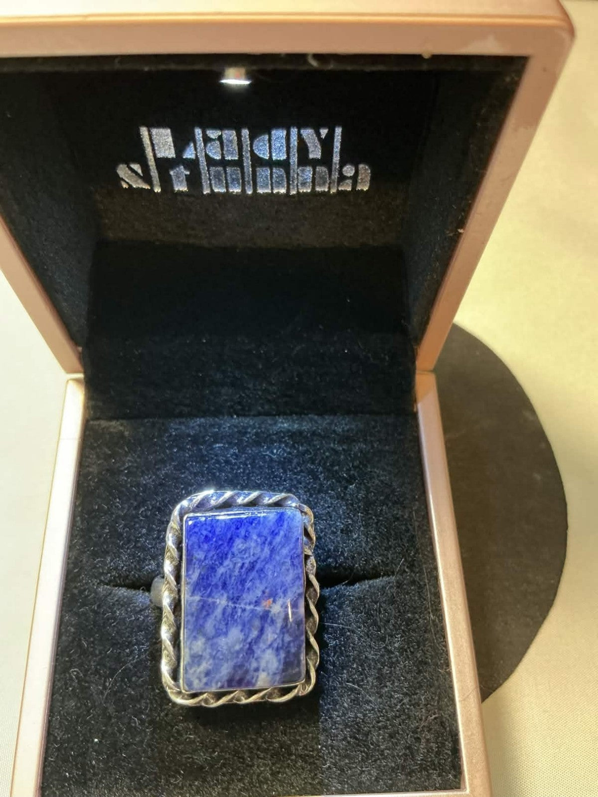sterling silver ring features a rectangular lapis lazuli gemstone.