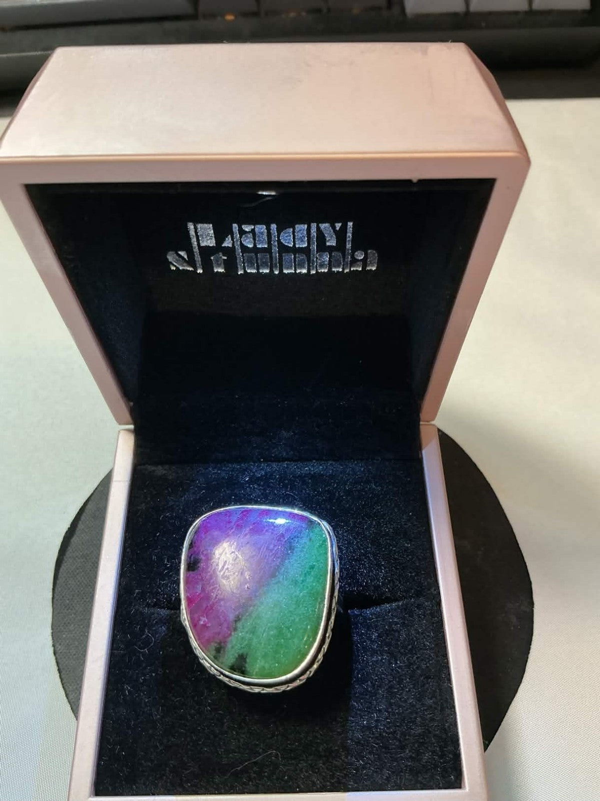 sterling silver ring featuring a multicolored rainbow solar quartz gemstone.