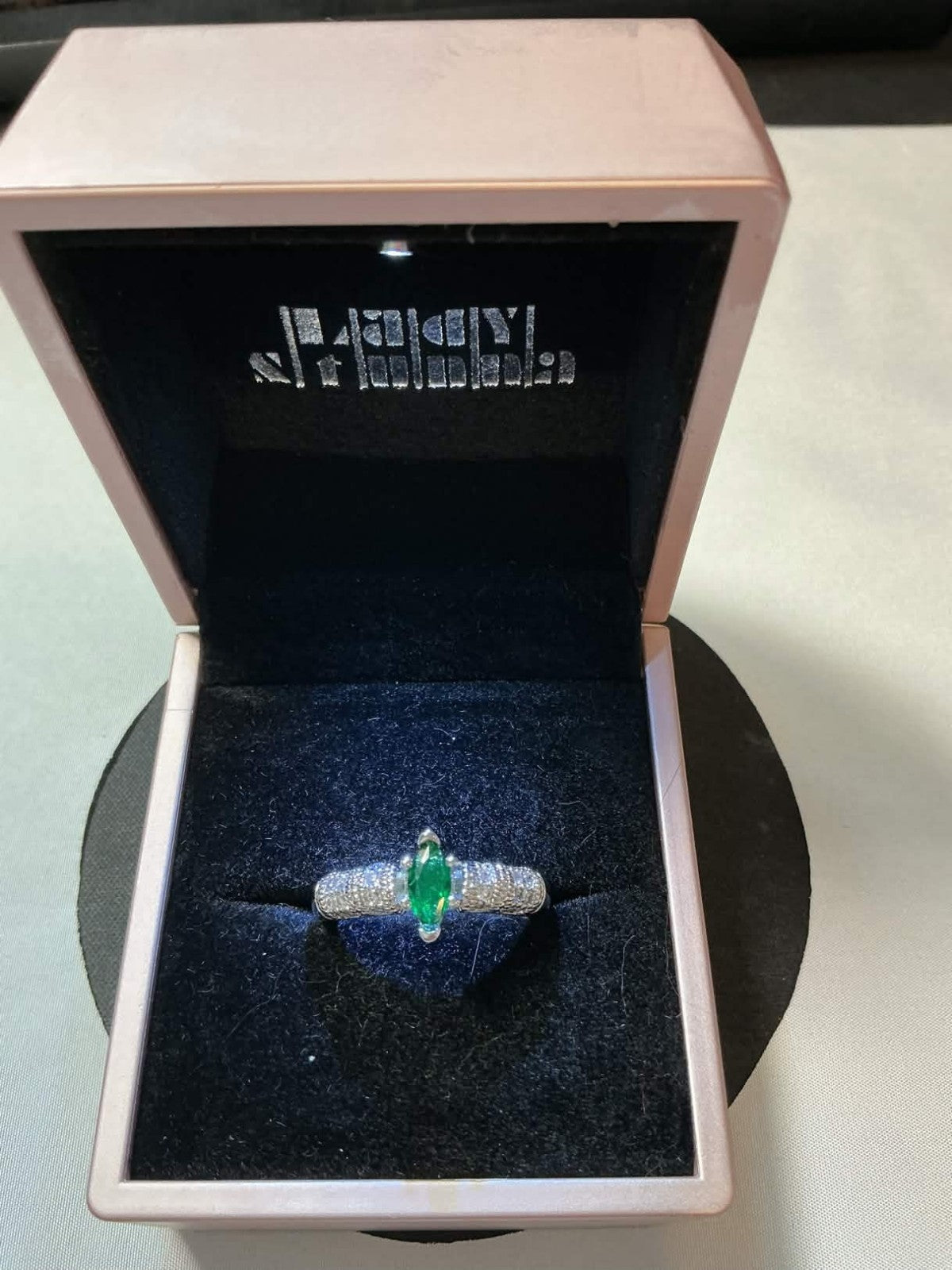 marquise-cut emerald surrounded by diamonds