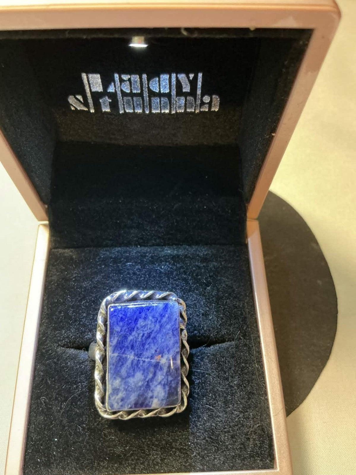 sterling silver ring features a rectangular lapis lazuli gemstone.