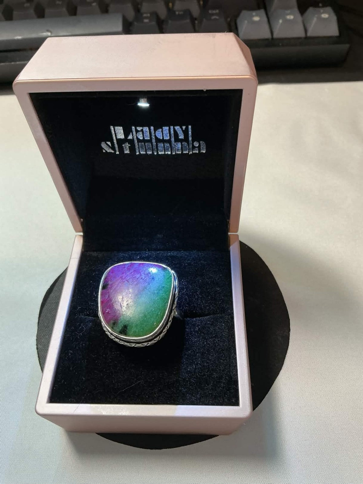 sterling silver ring featuring a multicolored rainbow solar quartz gemstone.