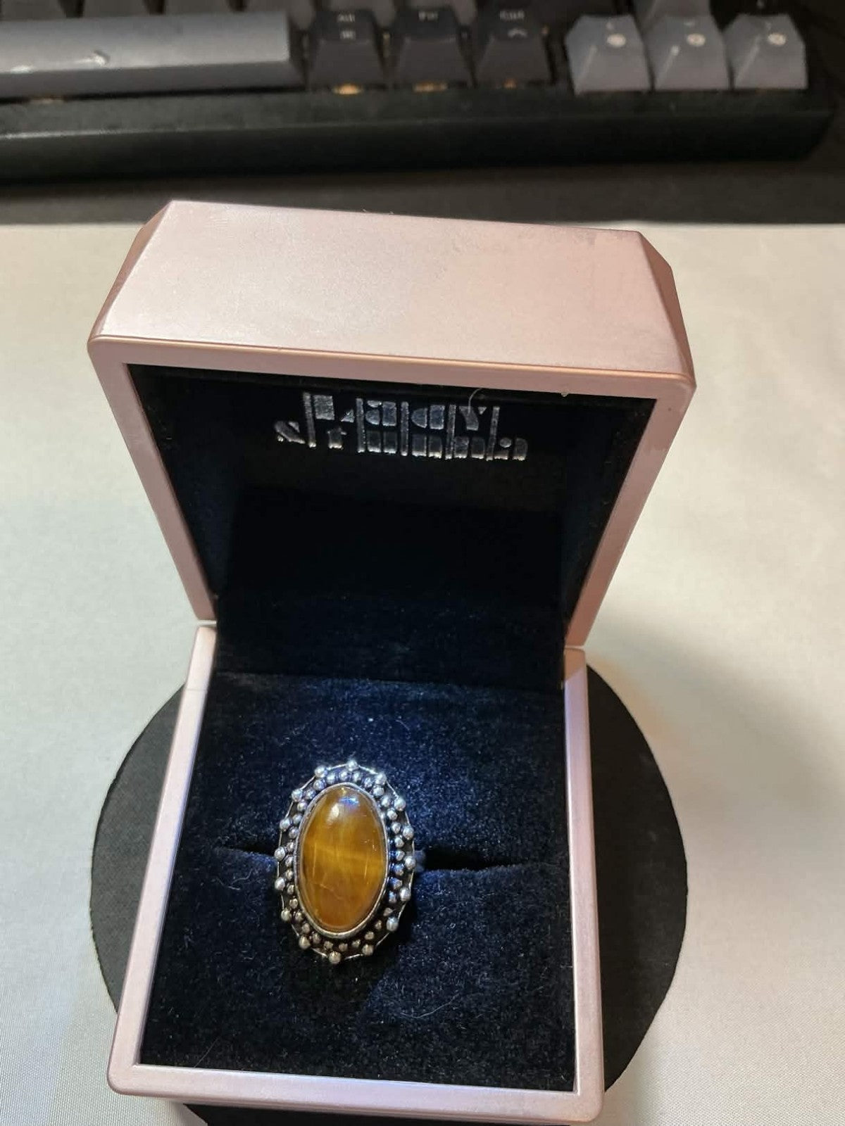 vintage sterling silver ring featuring a chatoyant tiger's eye gemstone in a bez
