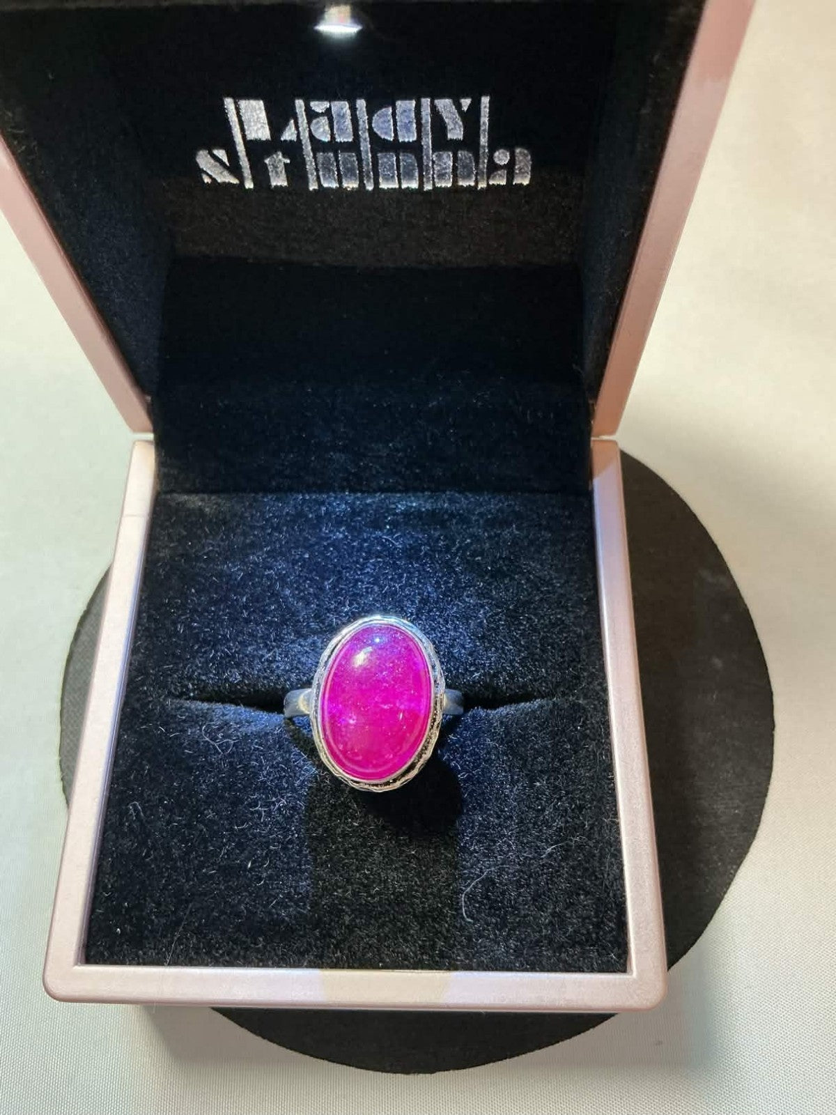 sterling silver ring featuring a pink corundum or chalcedony gemstone.