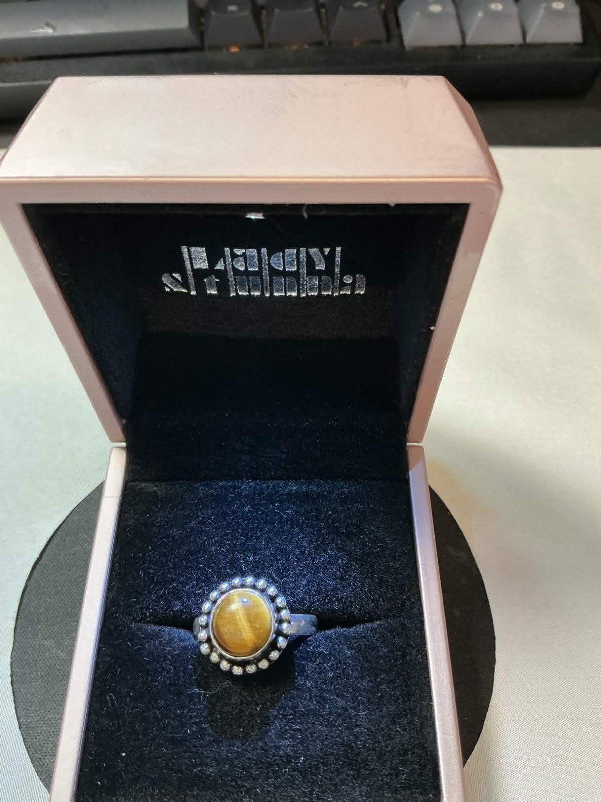This vintage Madeira ring features a tiger's eye stone set in 18kt gold electrop