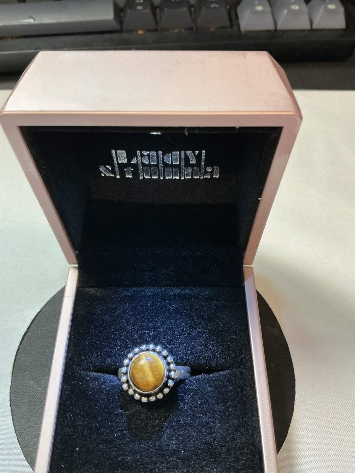 This vintage Madeira ring features a tiger's eye stone set in 18kt gold electrop